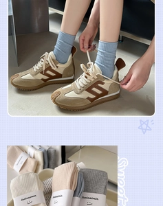 Detail of ribbed cotton socks with smiley face embroidery and retro sneakers