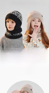 Detail of warm winter knitted baby hat and scarf set with ear protection and soft fleece lining