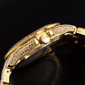 Macro side view of gold quartz watch case and strap links encrusted with sparkling zircons