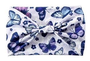 Detail of purple fabric headband featuring knot design with butterfly and flower patterns