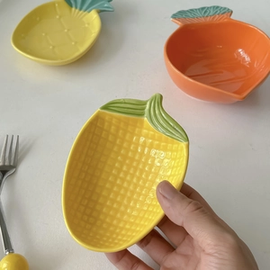 Ceramic fruit-shaped small dishes featuring pineapple, carrot, and corn designs