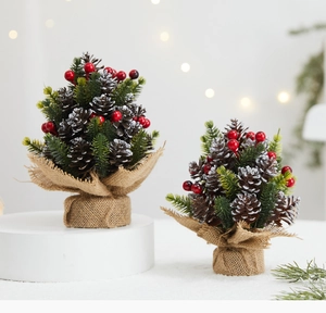 Close-up of pine cones, red berries and snow-flocked needles on burlap base trees
