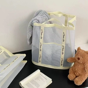 Detail of breathable white mesh laundry basket with 'A Better Life' slogan handles