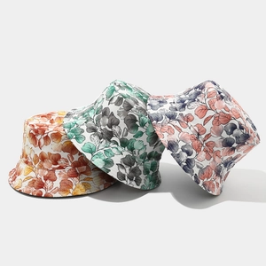 Detailed comparison of three tropical floral canvas bucket hats in various color patterns