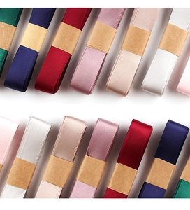 Detailed top view of colorful double-sided satin ribbon rolls in multiple elegant shades