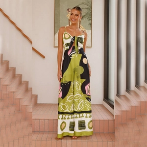 Detail of chest tie-up cutout and vibrant abstract print on a summer jumpsuit