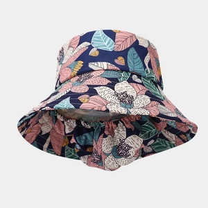 Detail view of wide brim sun hat with tropical floral print in navy and pink