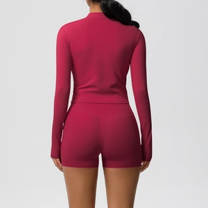 Close-up of ergonomic seams on a back view of a dark rose yoga set and cropped jacket