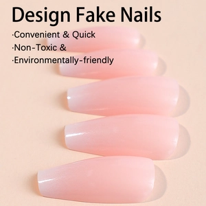 Long coffin shaped press-on nails featuring a soft pink gradient and glossy finish