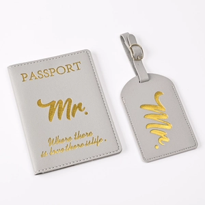 Close-up of grey PU leather passport cover and luggage tag with gold lettering