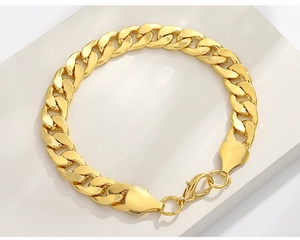 Detailed view of golden Cuban link chain bracelet with a secure lobster clasp closure