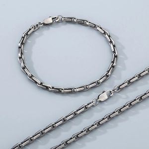 Close-up of vintage silver stainless steel bamboo chain necklace and bracelet set