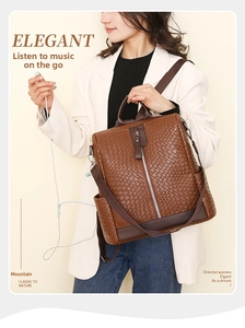 Detail of brown woven leather backpack showing a dedicated headphone jack for music