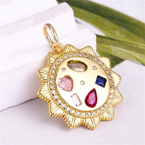 Macro shot of sun-shaped golden pendant with colorful zircon stones and shiny crystals