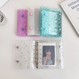 Macro detail of a 6-ring glitter star binder for photocards with metallic closures
