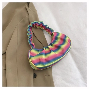 Close-up of rainbow gradient striped hobo bag with pleated shoulder strap detail