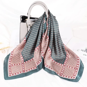 Dettaglio di un foulard di seta a righe legato a una borsa in pelle in una scena di stile