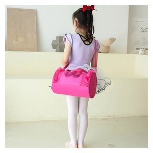 Rear view of child pink ballet bag with lace trim and adjustable strap in studio