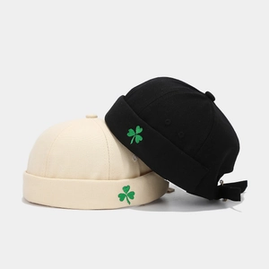 Fashionable miki hats in black and beige with clover embroidery and adjustable strap