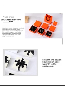 Detailed view of luxury orange and white jewelry gift boxes with satin ribbon and gift bags
