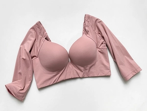 Detail of dusty pink yoga top with long sleeves, V-neckline and integrated padded bra