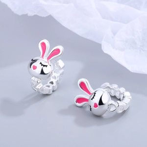Pink heart bunny hoop earrings in silver minimalist style with soft textured background