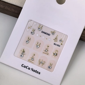 Detailed view of K9 crystal Christmas nail art stickers featuring golden reindeer and snowmen