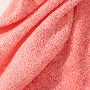 Macro view of soft coral pink microfiber fabric showing plush thick texture