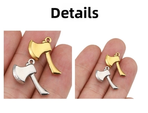 Detailed macro view of mini gold and silver axe charms for DIY jewelry making accessories