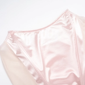 Detail of pink satin corset featuring delicate mesh stitching and smooth fabric texture