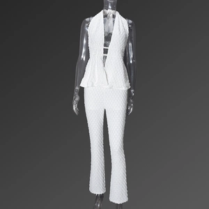 Macro shot of white halter crop top and trousers featuring unique popcorn bubble texture