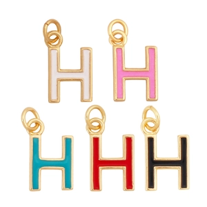 Detailed view of colorful enamel letter H pendants in gold finish with jump rings
