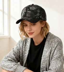Detailed view of black baseball cap with silver ink painting floral pattern texture