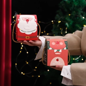 Christmas gift boxes with Santa and reindeer designs featuring golden braided handles