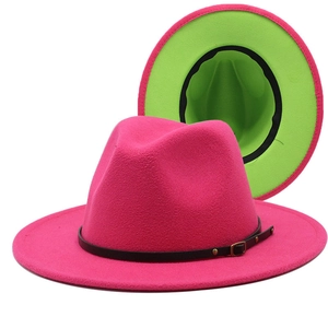 Detail of fuchsia wool jazz hat showing black leather belt and green brim underside
