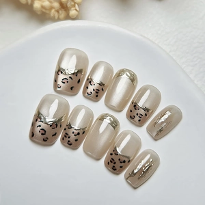 Handmade leopard print press-on nails with 3D cat eye effect and gold metallic edges