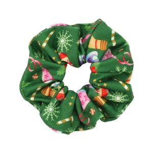 Detail of green Christmas scrunchie featuring snowflake and candy cane patterns