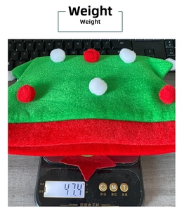 Weight measurement of the green and red Christmas tree hat showing 47.4g on a digital scale