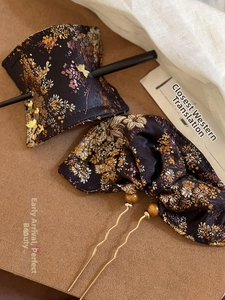 Detail of Chinese style jacquard floral brocade hairpins with traditional wooden sticks