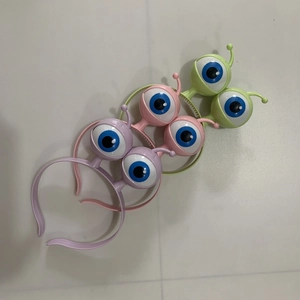 Three LED flashing eyeball headbands in purple, pink, and green for Halloween party decor