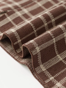 Macro view of brown and beige plaid knit fabric texture and high-quality weaving detail
