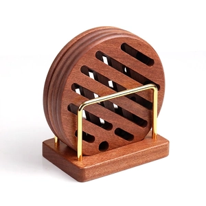 Round ebony wood coasters set with hollow design and golden metal storage stand