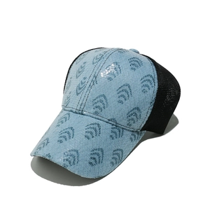 Detail of blue sequin wave pattern and breathable black mesh on the baseball cap