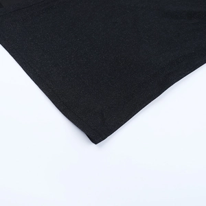 Detailed close-up of black knit fabric texture and high-quality stitching on the dress