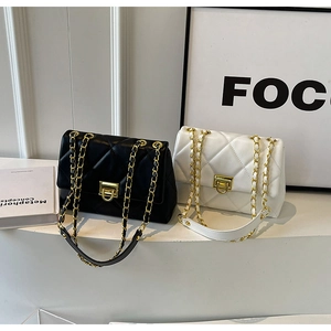 Detail of classic quilted crossbody bags with chain straps and gold twist locks