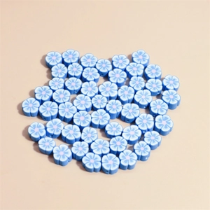 Macro view of light blue polymer clay flower beads for DIY jewelry making and bracelets