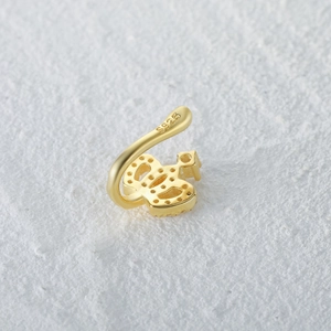 Close-up of golden crown nose cuff with sparkling zircons and S925 silver hallmark