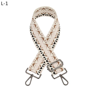 Detail of adjustable geometric guitar-style strap with dark grey metal lobster clasps