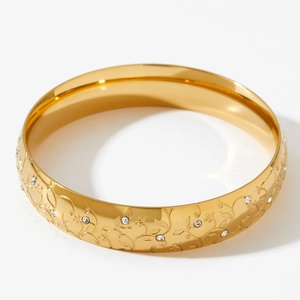 Classic gold stainless steel bangle with floral vine engraving and sparkling zircons