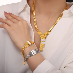 Polished 18k gold plated Y pendant necklace and zircon bracelets on a female model